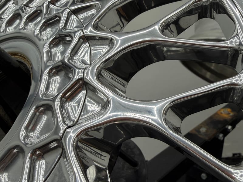 Close-up of mirror-polished mesh spokes